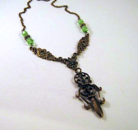 Antiqued bronze sword necklace jewelry with green teardrop beads