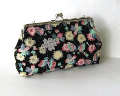 Butterflies and flowers on black clutch frame bag with removable strap